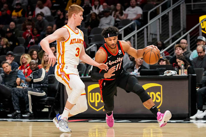 Mar 14, 2022; Atlanta, Georgia, USA; Portland Trail Blazers guard Josh Hart (11) dribbles against Atlanta Hawks guard Kevin Huerter (3) during the first half at State Farm Arena.